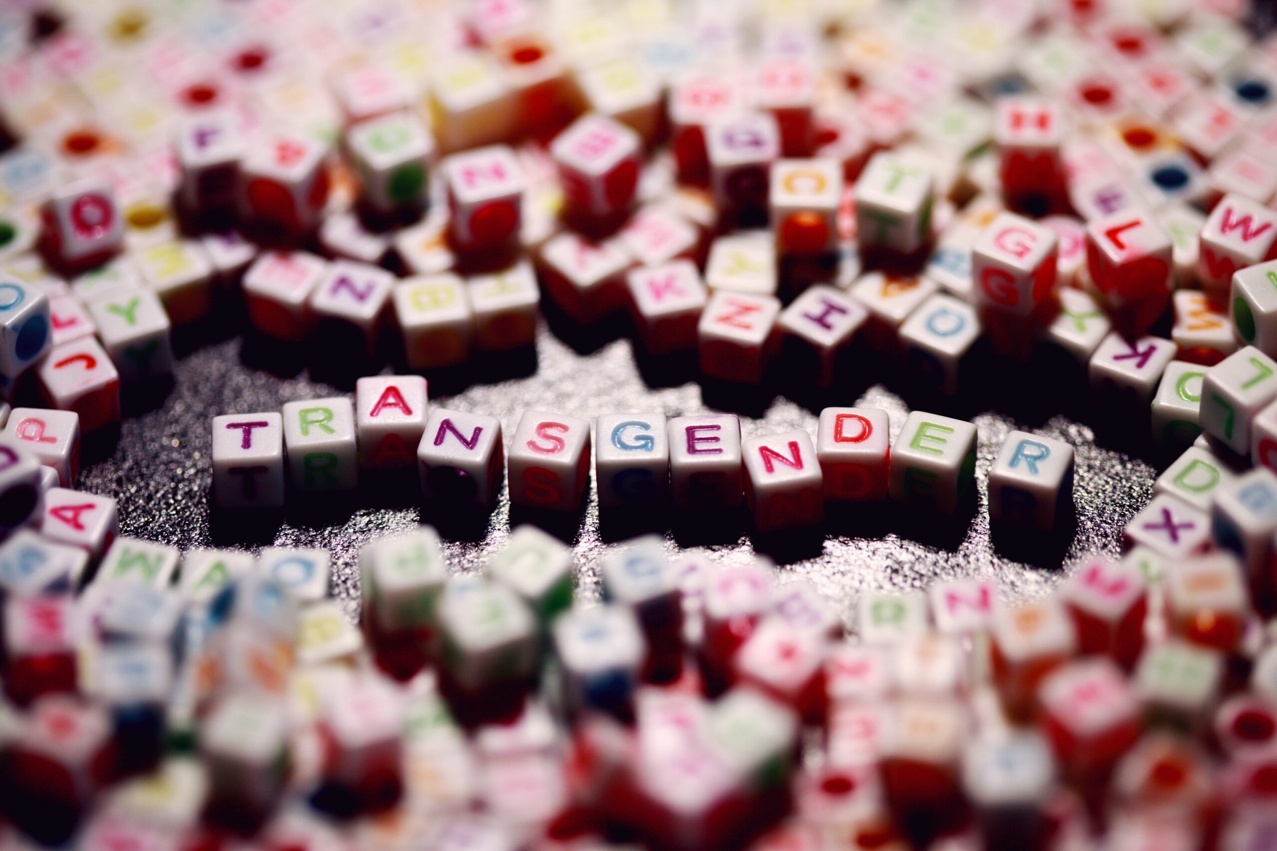 A picture of toy building blocks spelling the word transgender for support of an article on gender-affirming care in Canada