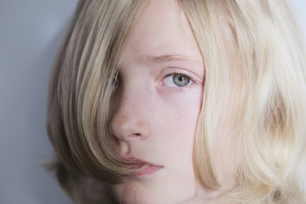 Photo of a child with light skin and long blond hair to support a transgender child
